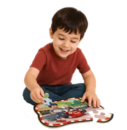 Chłopiec układa puzzle z motywem pojazdów